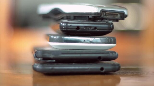 old mobile phones piled up on a table no people stock video stock footage