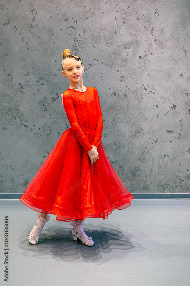 Wall mural happy girl in a red long dress on a gray background before a ballroom dancing tournament