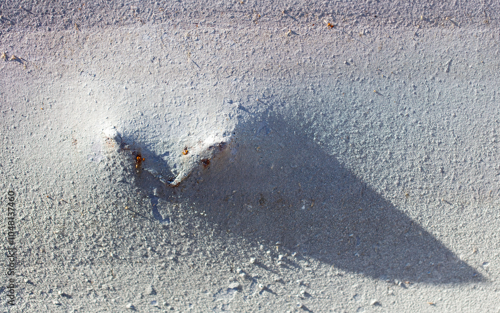 Canvas Prints a shadow of a heart is cast on a grey surface