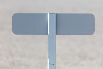 A white sign with a black letter T on it