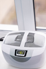 Modern dental equipment on a workstation with a digital display inside a dental clinic during daylight
