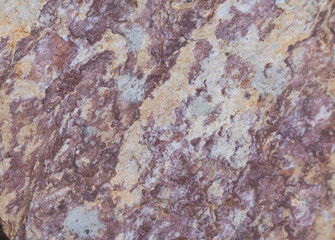 Obraz premium Multi-colored stone floor, the stone texture is purple, white and orange, the stone pattern is similar to the grain, rough texture, stone background, abstract background.