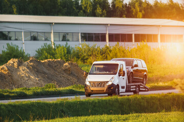 SUV on tow truck driving through rural area