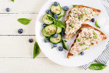 Toasts with tuna. Italian bruschetta sandwiches with pate canned tuna, egg and cucumber. Top view, flat lay,