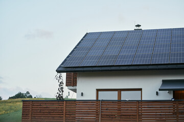 Solar panels on rooftop providing renewable energy for house