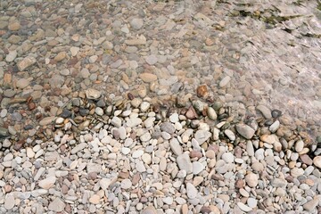 River Shoreline with Smooth Rocks and Pebbles