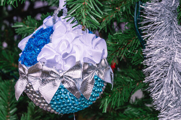 Christmas decoration, blue and white with bows, on the Christmas tree on the eve of the New Year...