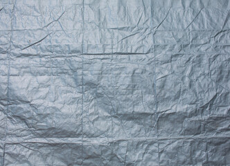 Fototapeta premium The wrinkled texture of the gray canvas background