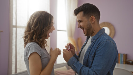 Man proposing to surprised woman with a ring in an indoor home setting, capturing love, joy, and relationship in a beautiful moment together.