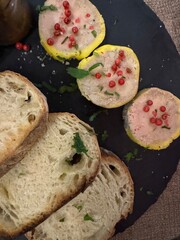 Foie gras garnished with red peppercorns and herbs