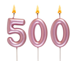 Burning pink birthday candles isolated on white background, number 500