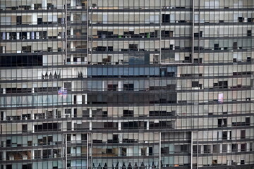 Abstract architectural exterior detail of glass windows of a high rise tower building