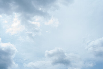 Obraz premium Fluffy white clouds drift across a vast, blue sky