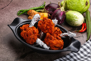 Indian cuisine glazed chicken lollipop