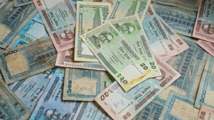 Bangladeshi banknotes spread out showing various denominations of taka, highlighting the currency used in bangladesh with intricate designs and colors.