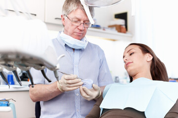Man, dentist and woman with mould at clinic for cleaning treatment, veneers assessment and teeth...