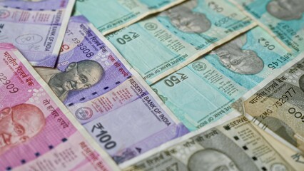 Indian rupee banknotes spread out showcasing various denominations including 50, 100, and 2000 with intricate designs, representing currency and finance in india.