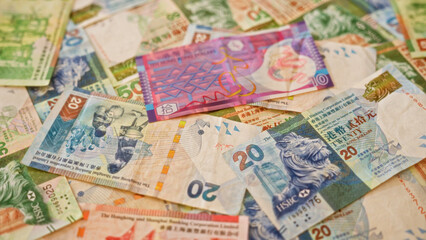 Colorful hong kong dollar banknotes in various denominations scattered across a surface showcasing vibrant currency design and financial elements