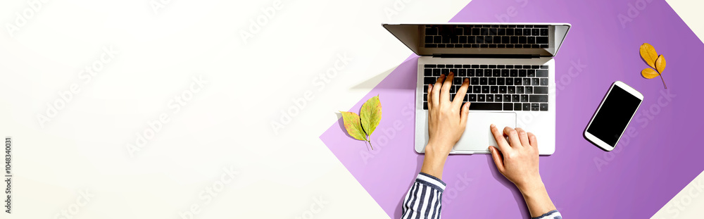 Poster autumn leaves with person using a laptop computer from above