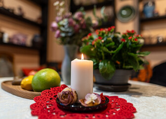 still life with white candle, dry flowers, fruits and other objects