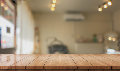Empty wooden table top with lights bokeh on blur restaurant background.	

