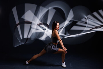 young girl sportswoman doing sports in neon light, concept modern sports training,