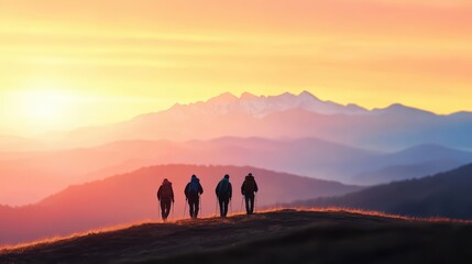 Group of hikers trekking through mountains during a vibrant sunset.