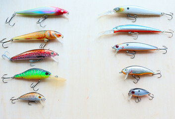 Set of fishing lures for predatory fish, on wooden background