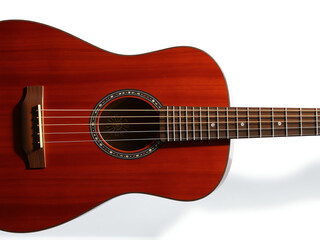 Fototapeta premium Acoustic guitar against a white background highlighting its craftsmanship and rich wood tones for music enthusiasts