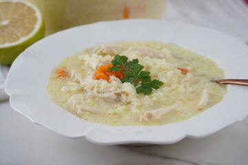 Avgolemono - traditional greek chicken soup with rice, lemon and eggs, traditional greek chicken
