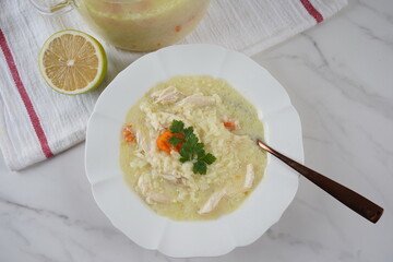 Avgolemono - traditional greek chicken soup with rice, lemon and eggs, traditional greek chicken