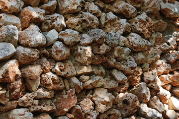Old beige stone wall background texture. The wild stones decorative wall. Natural limestone background or surface