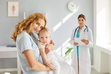 Portrait of a mother hugging baby during a consultation during hospital or clinic visit....