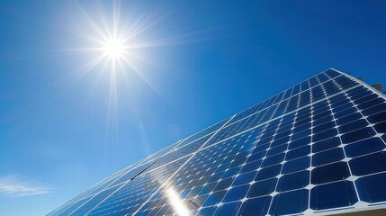 A solar panel array facing the sun on a clear blue sky day