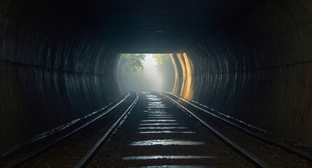 A view from inside a dark, misty tunnel.
