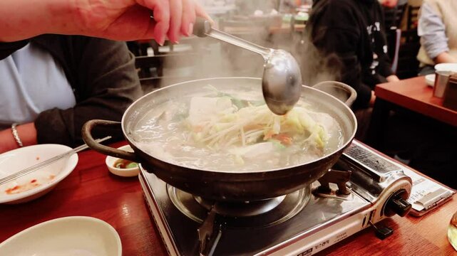 Fish and seafood hotpot cooking close up view in the traditional restaurant in Seoul Korea