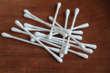New white cotton buds or cotton swab or Q-tips, on wooden background, top view