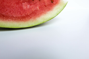 A piece cut of ripe red watermelon, isolated on white background, side view, space for text
