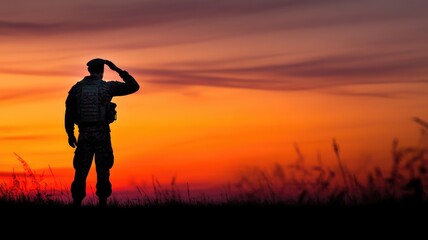 Soldier salutes at sunset in silhouette against colorful sky, representing service and dedication
