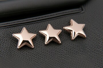 A pair of gold star stud earrings on a black background - Backgrounds