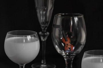 Miniature Violin still life on a wine glass