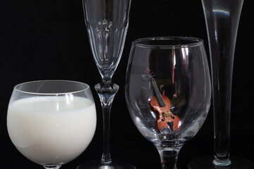 Miniature Violin still life on a wine glass