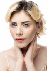 Naklejka premium A young blonde girl with clear skin in a satin top. Beauty portrait of a woman on a white background in the studio.