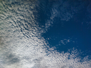 Mottled sky formed by Altocumulus stratiformis clouds. 
fleece-shaped clouds and blue sky. cirrocumulus clouds. Indonesia