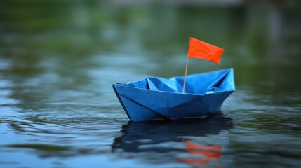 Fototapeta premium Paper Boat Floating on Water with Orange Flag