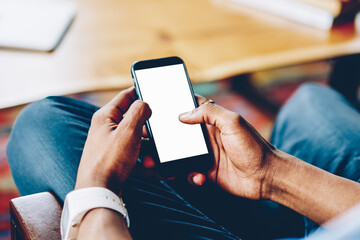 Black person browsing smartphone at table on meeting