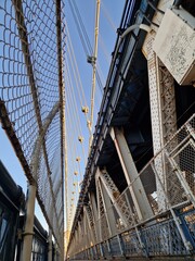 Obraz premium Lonely road, don't know where it goes, Bridge of Steel in New York City view up to the sky