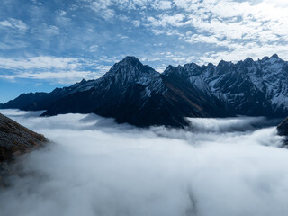 Obraz premium Aerial view of beautiful snow capped mountains and autumn forest landscape