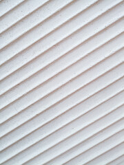 Minimalist style background from a concrete wall with simple but beautiful diagonal lines.