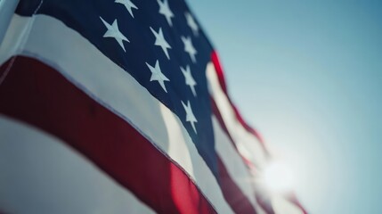 American Flag Waving in the Breeze Against a Clear Blue Sky